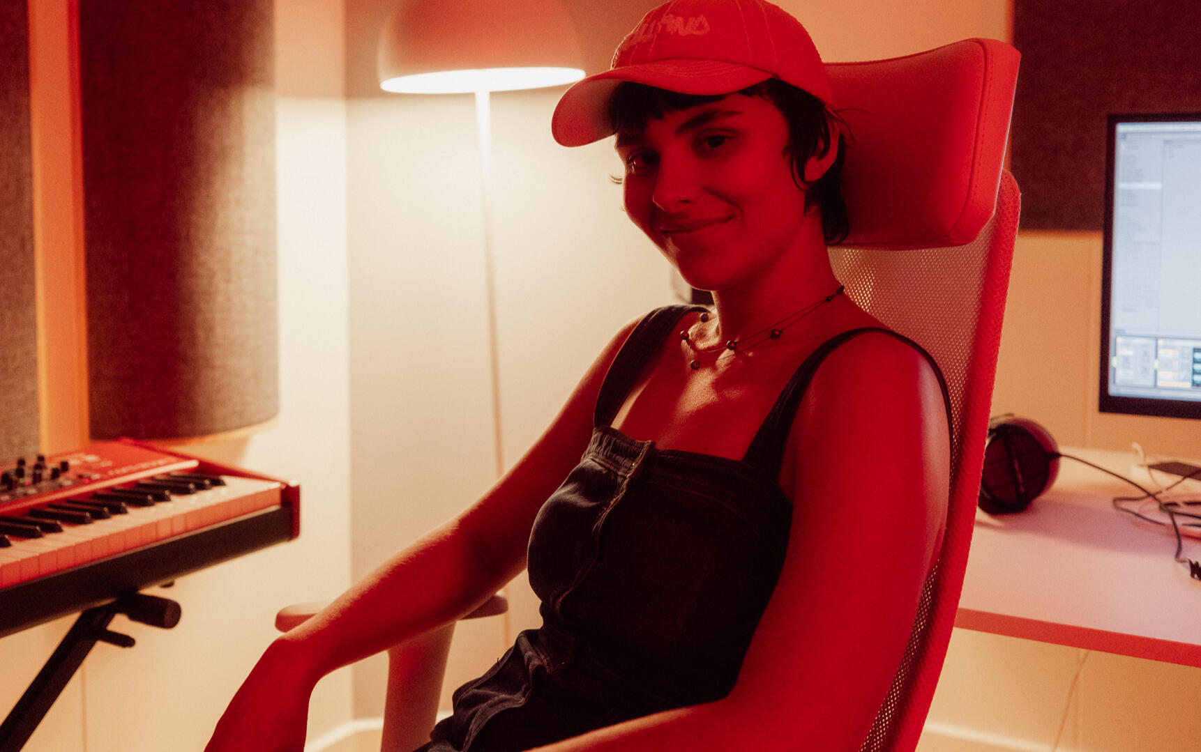 Prudns sitting in her music studio looking at the camera. She looks happy.